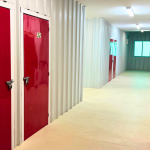 Storage hallway with red doors and window