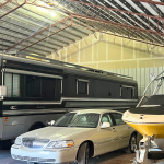 Indoor rv storage storing boat, rv and car.